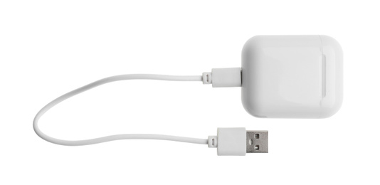Photo of USB charge cable and wireless earphone case on white background. Modern technology