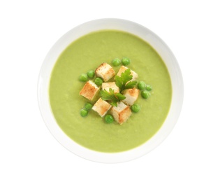 Photo of Fresh vegetable detox soup made of green peas with croutons in dish on white background, top view