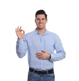 Photo of Happy healthy man touching his belly on white background