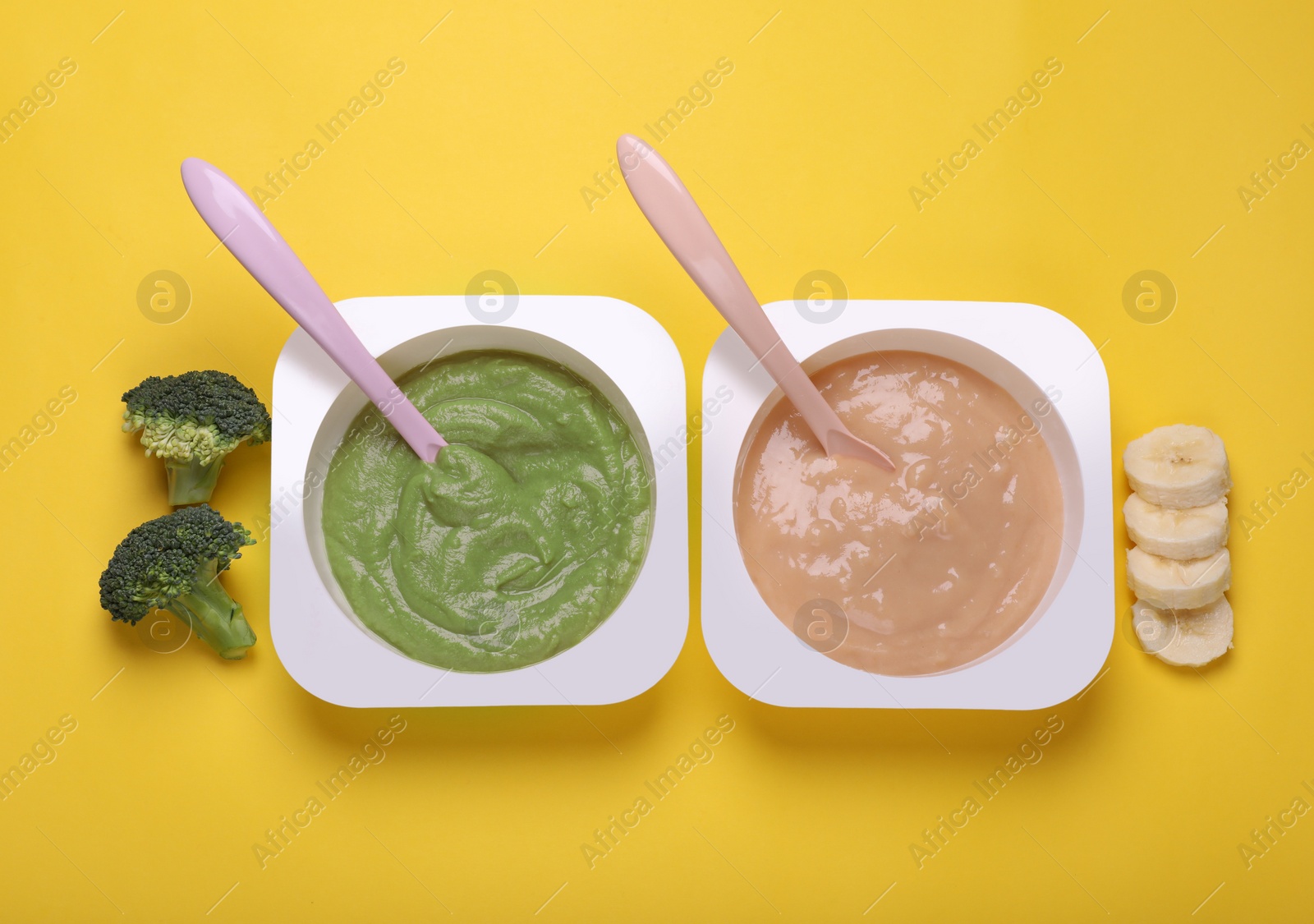 Photo of Bowls with healthy baby food and ingredients on yellow background, flat lay