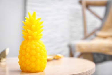 Pineapple shaped candle on table in room