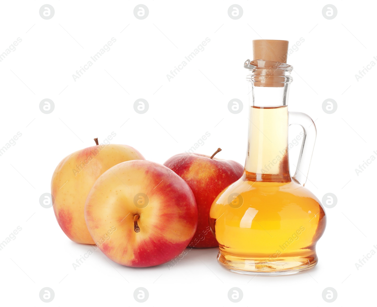 Photo of Glass jug of vinegar and fresh apples on white background