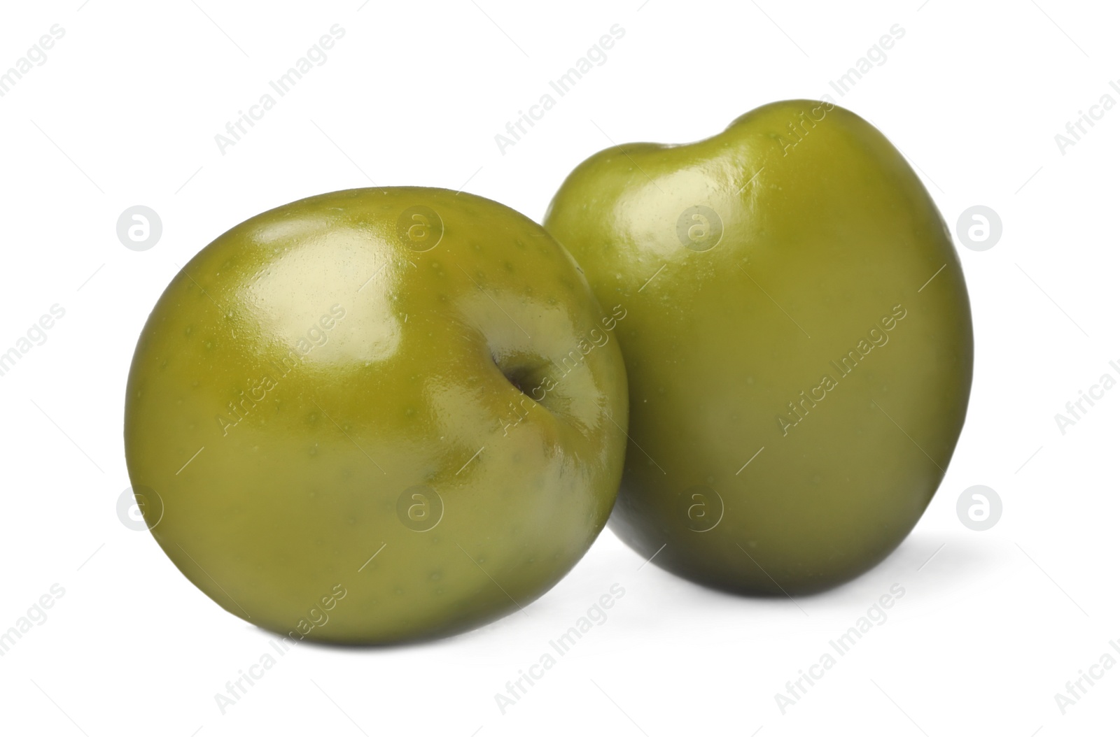 Photo of Two fresh green olives on white background