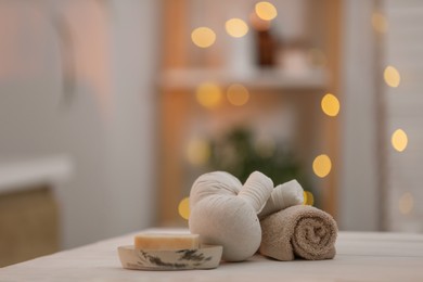 Photo of Composition with spa herbal bags on white wooden table indoors, space for text