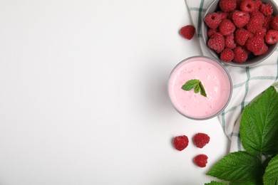 Tasty fresh raspberry smoothie on white table, flat lay. Space for text