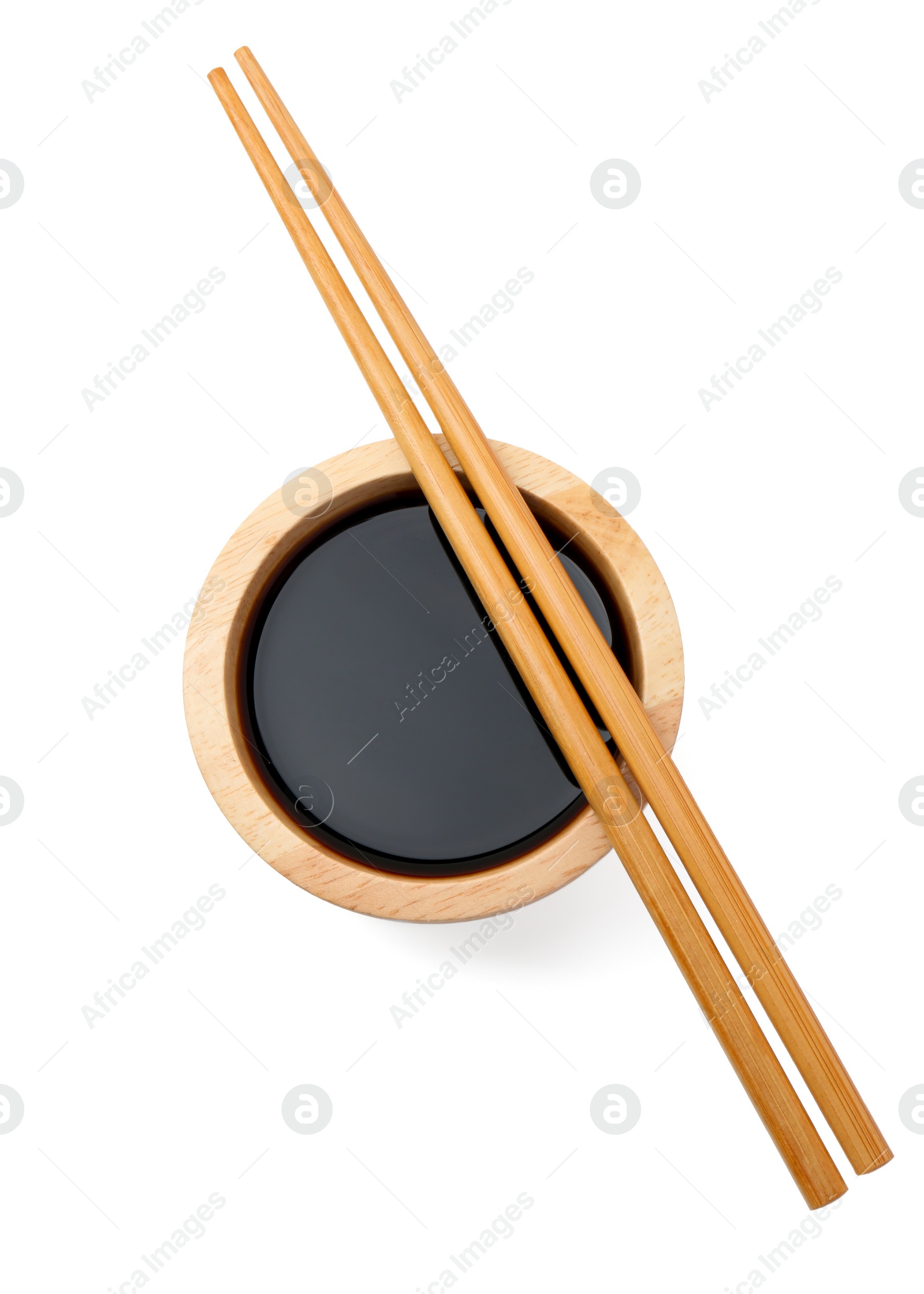 Photo of Tasty soy sauce in bowl and chopsticks isolated on white, top view