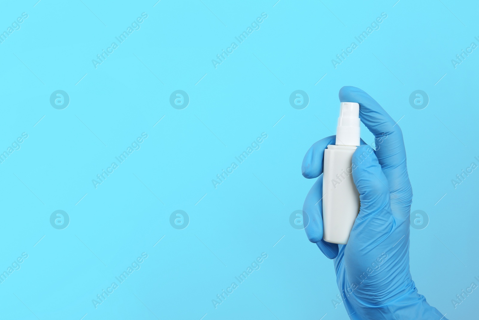 Photo of Dentist holding oral spray on color background, space for text. Mouth and teeth care