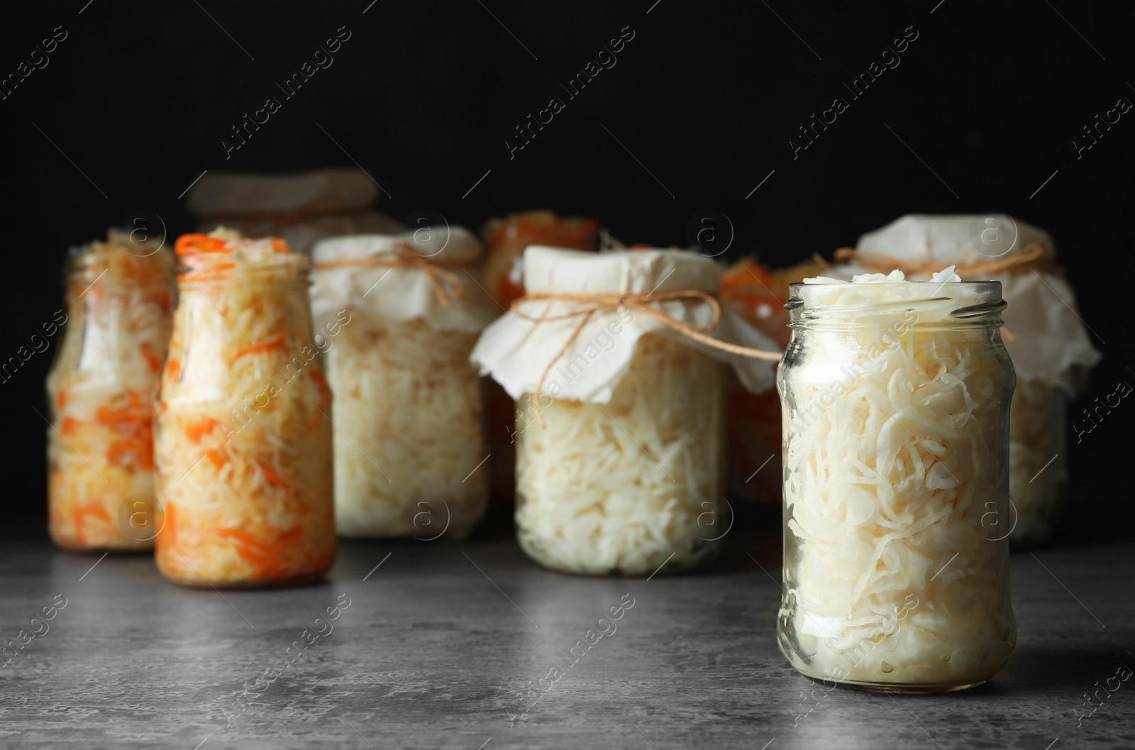 Photo of Tasty homemade fermented cabbage on grey table