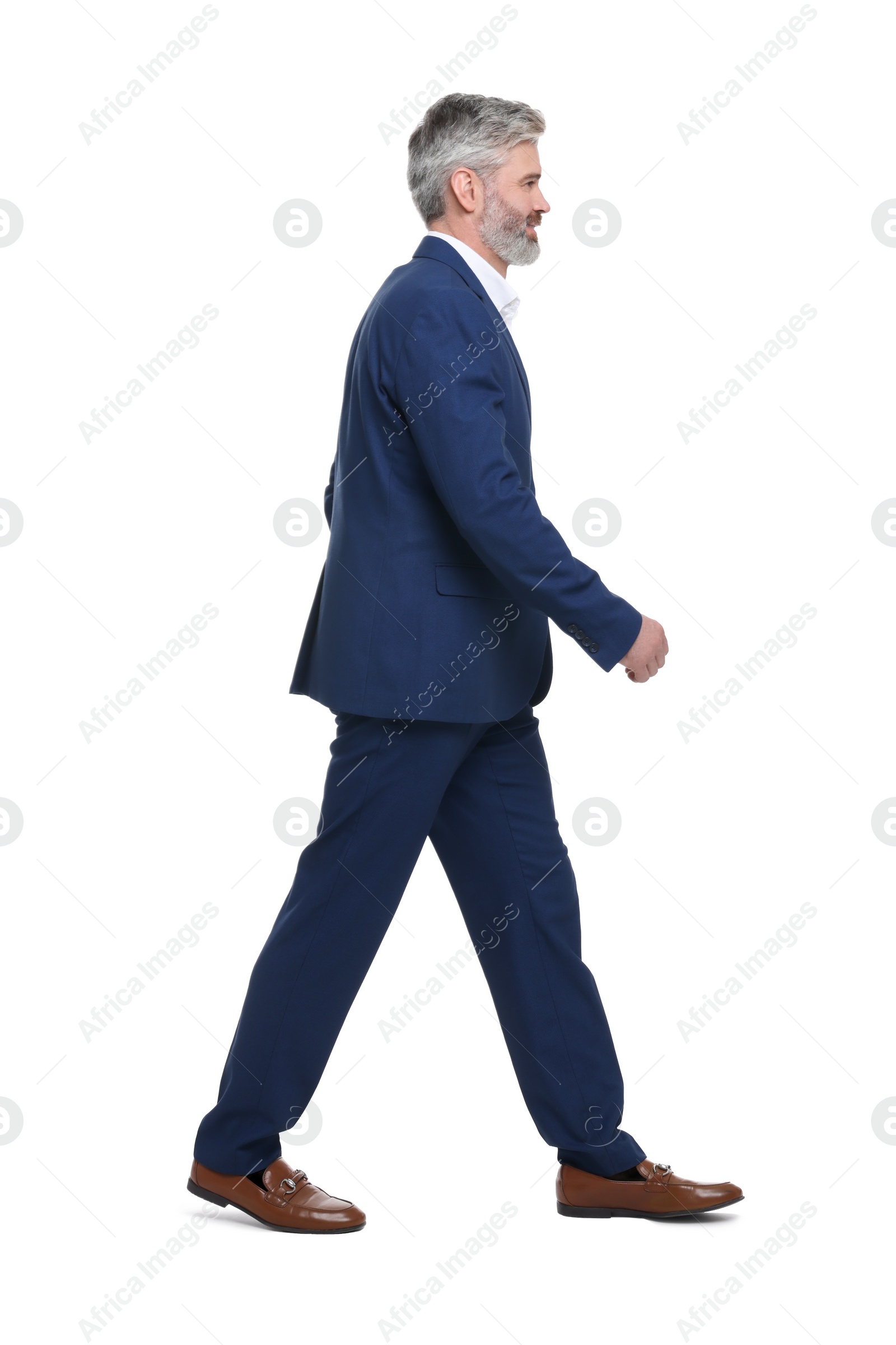 Photo of Mature businessman in stylish clothes posing on white background