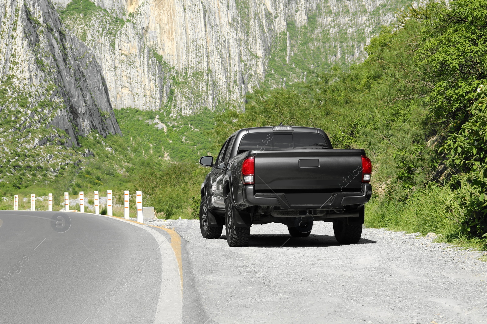 Photo of Picturesque view of black car on mountain road