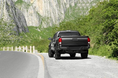 Picturesque view of black car on mountain road