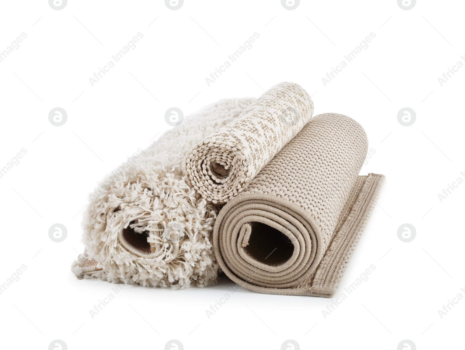 Photo of Different rolled carpets on white background. Interior element