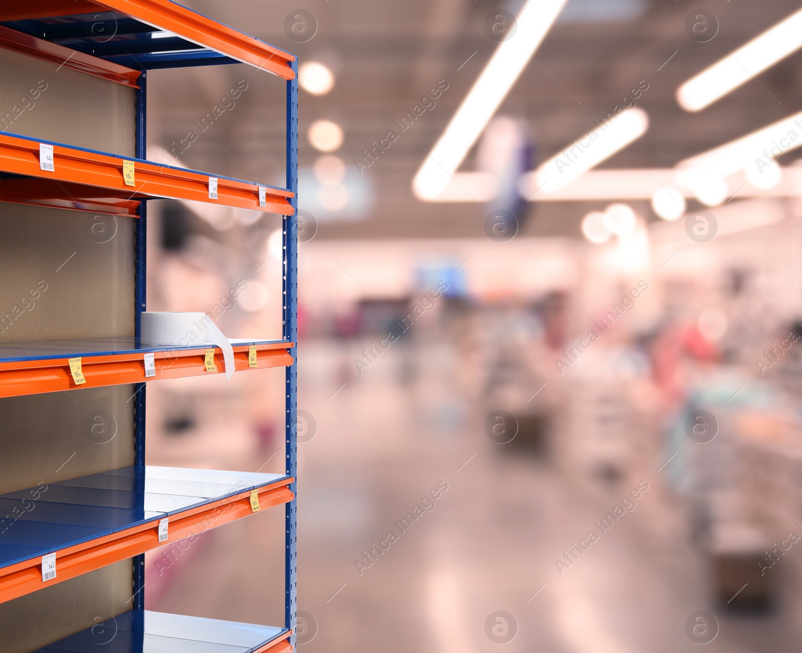 Image of Almost empty shelves in supermarket, closeup. Product deficiency due to social panic 