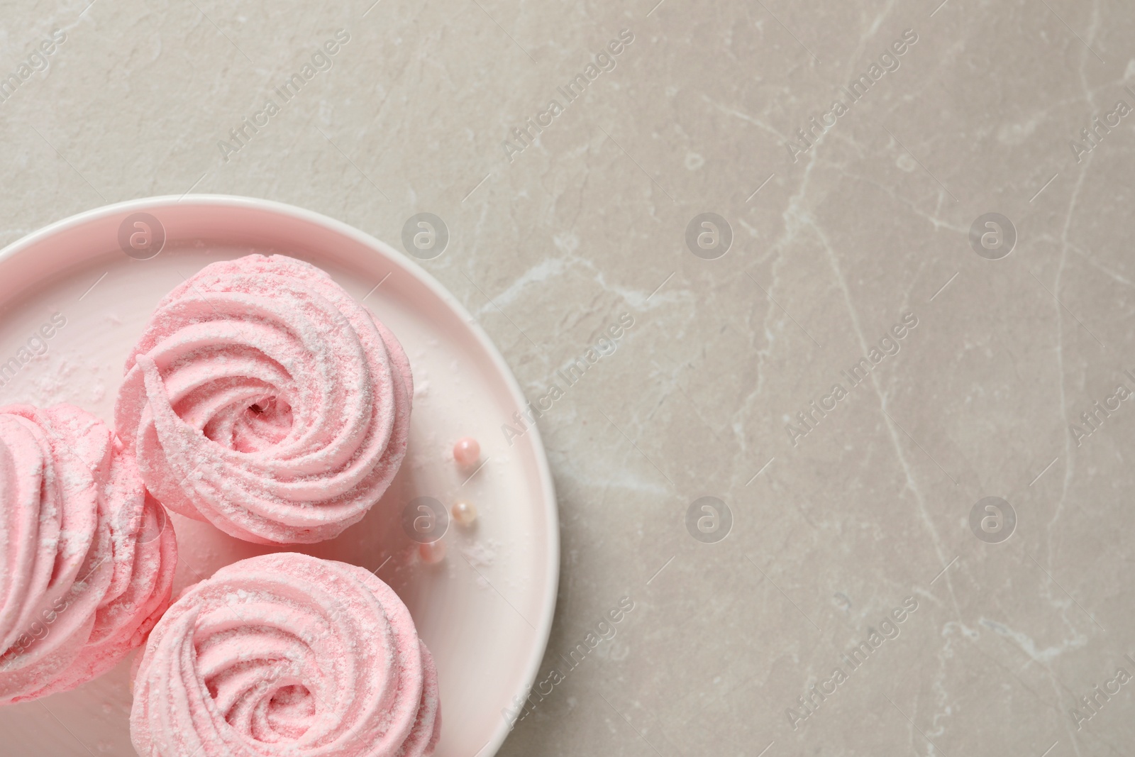 Photo of Delicious pink marshmallows on light grey table, top view. Space for text