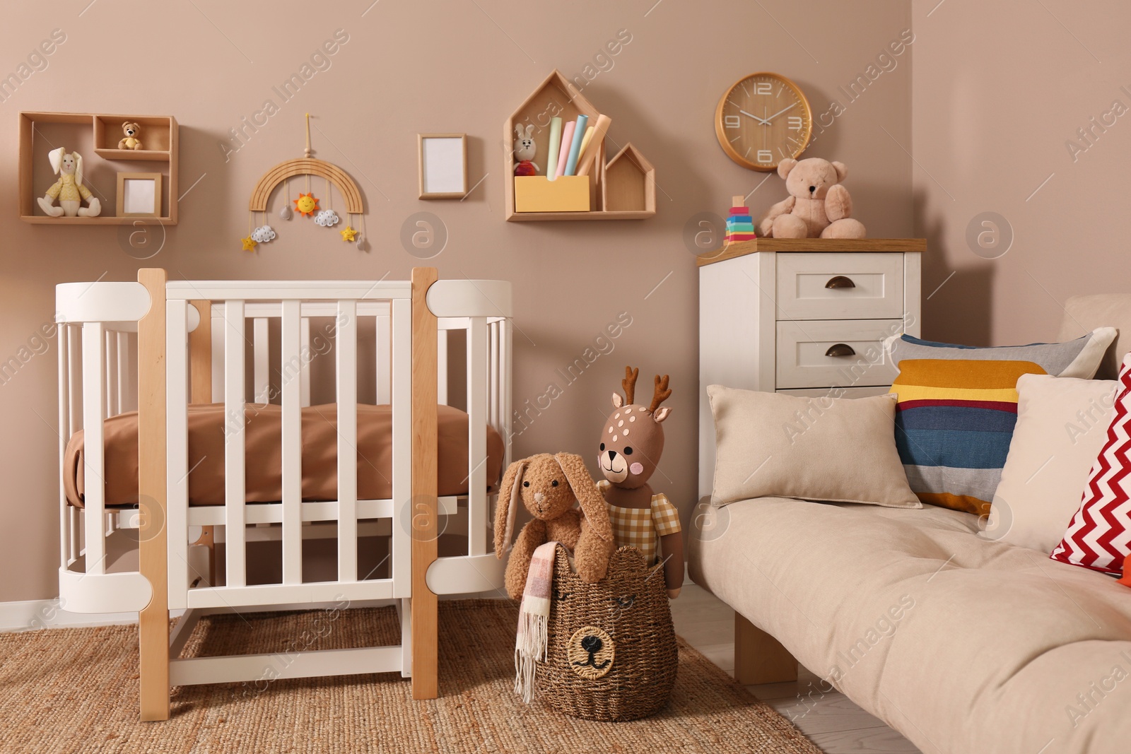 Photo of Baby room interior with stylish furniture and comfortable crib