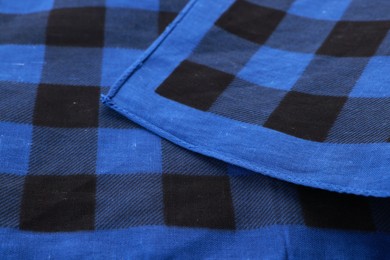 Photo of Closeup view of blue bandana with check pattern as background