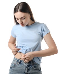 Diabetes. Woman making insulin injection into her belly on white background