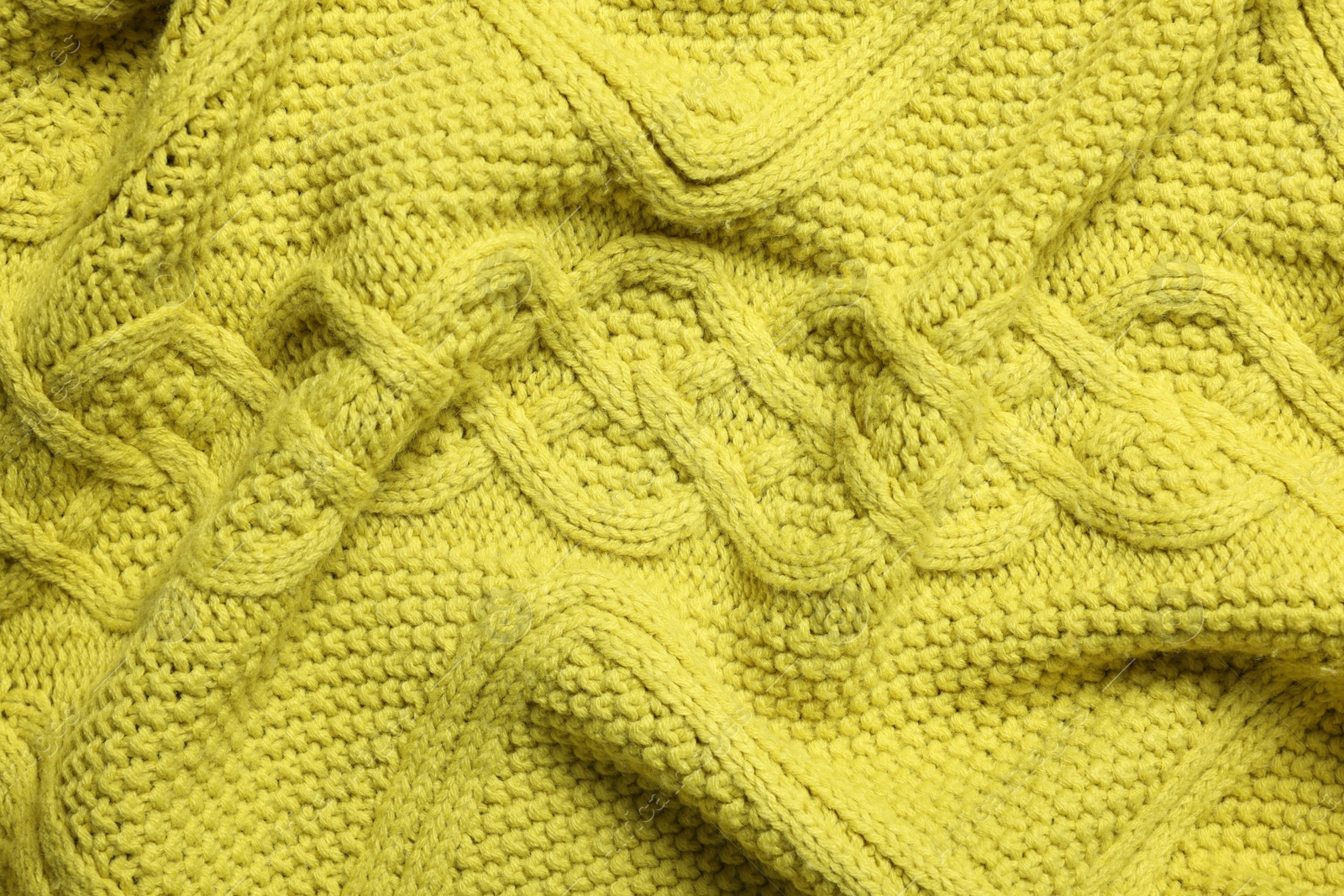 Photo of Texture of soft yellow fabric as background, top view