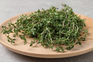 Bunch of aromatic thyme on light grey table, closeup