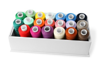 Different colorful sewing threads in box on white background