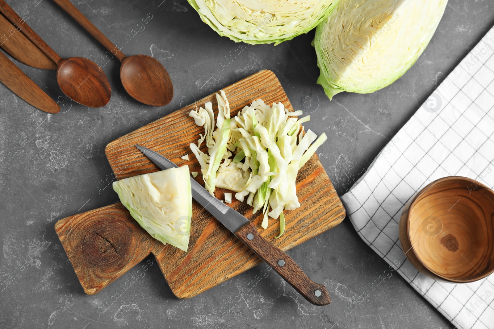 Photo of Flat lay composition with cutting board and chopped cabbage on table