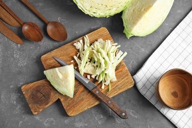 Flat lay composition with cutting board and chopped cabbage on table