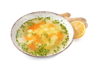 Photo of Bowl of fresh homemade soup to cure flu, lemon and ginger on white background