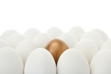 Golden egg among ordinary ones on white background, closeup