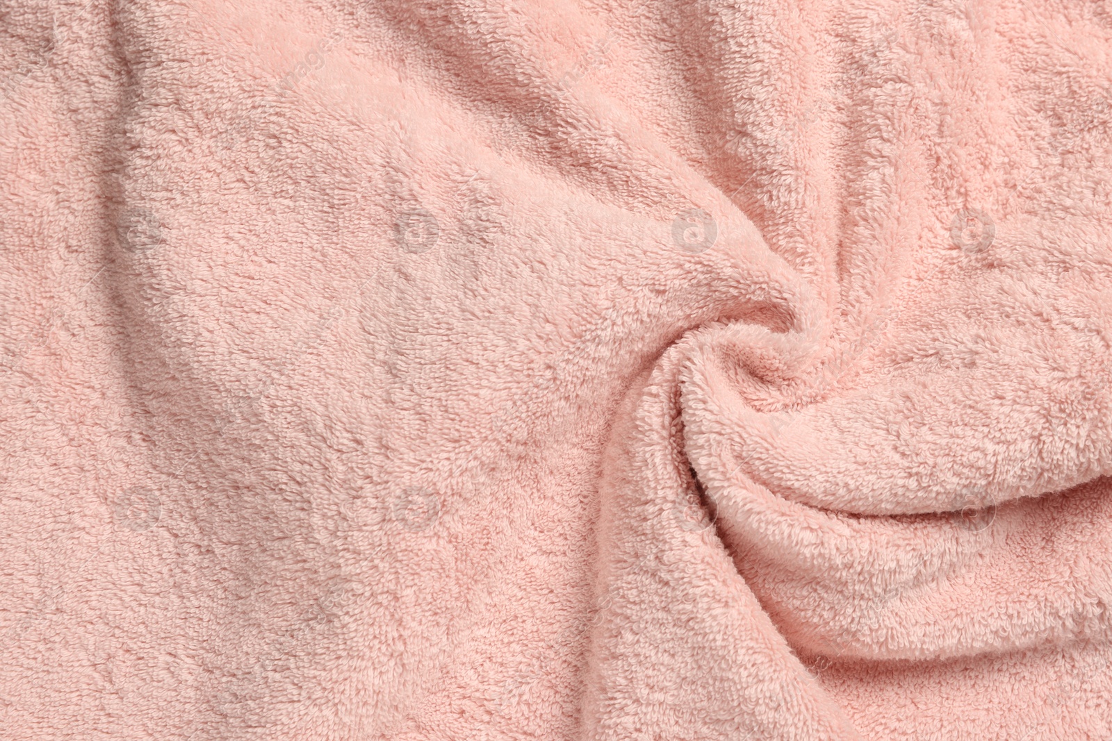 Photo of Soft crumpled pink towel as background, top view