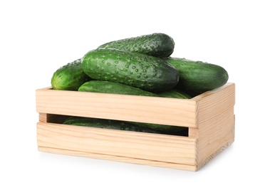 Wooden crate full of fresh ripe cucumbers on white background