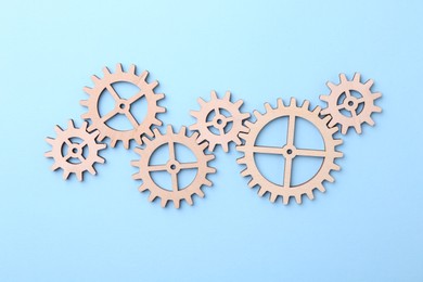 Business process organization and optimization. Scheme with wooden figures on light blue background, top view