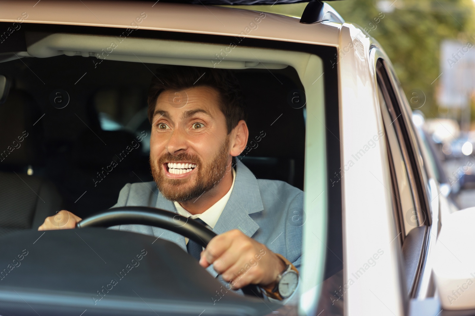 Photo of Stuck in traffic jam. Emotional driver in his car, view through windshield