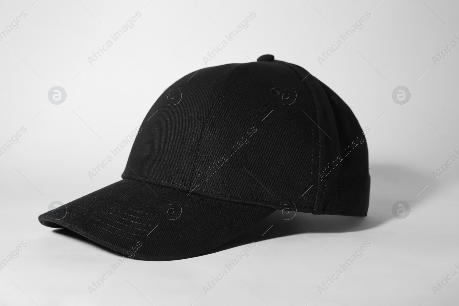 Photo of Stylish black baseball cap on white background