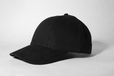 Photo of Stylish black baseball cap on white background