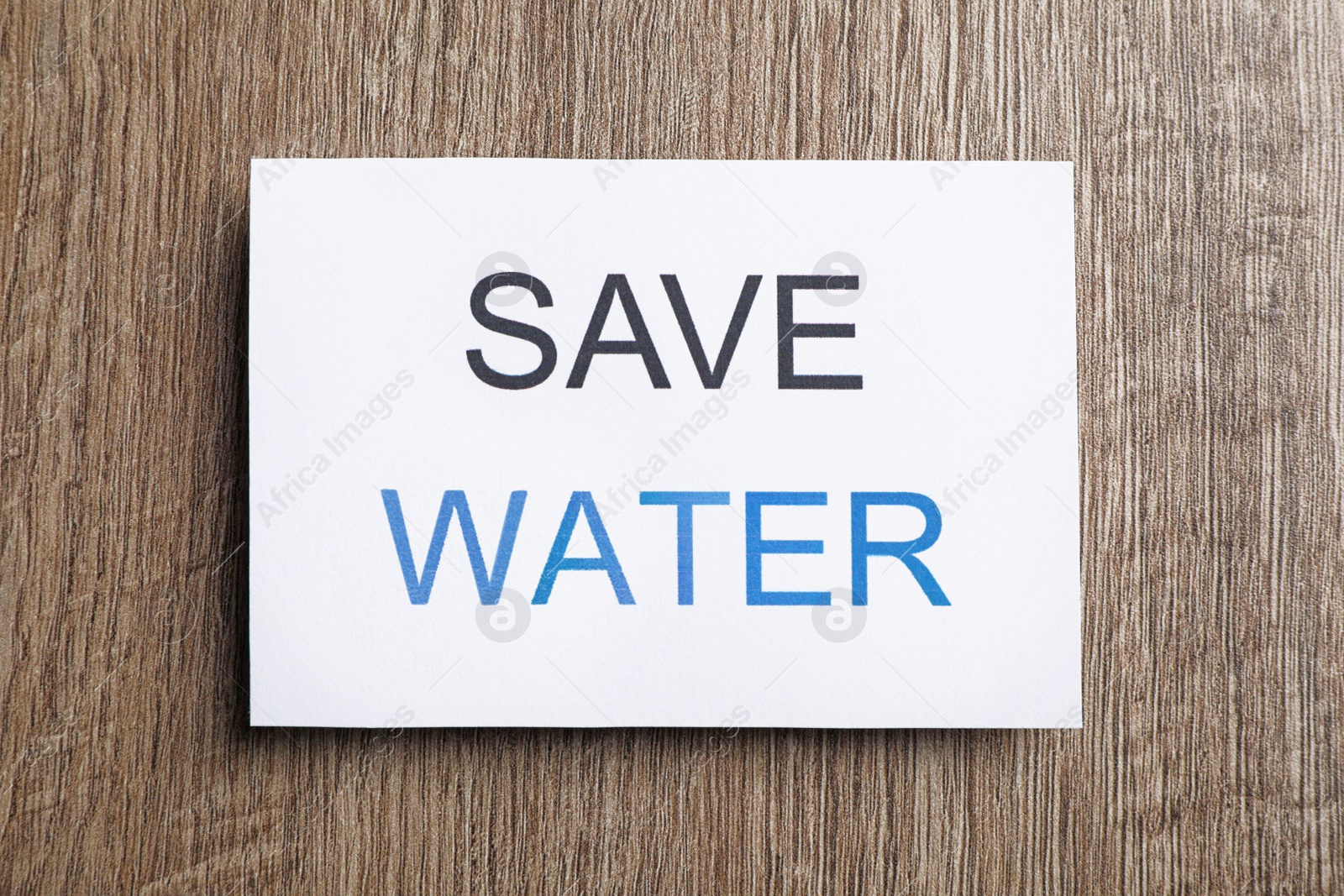 Photo of Card with words Save Water on wooden table, top view