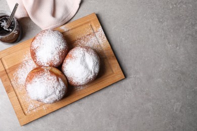 Photo of Delicious sweet buns with jam on gray table, flat lay. Space for text