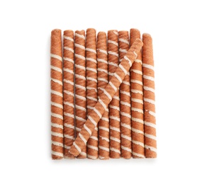 Photo of Delicious chocolate wafer rolls on white background, top view. Sweet food