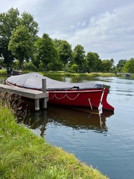 Photo of Beautiful view of canal with moored boat on sunny day