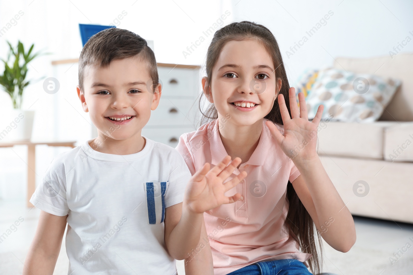 Photo of Little children using video chat at home, view from web camera