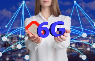 Image of Woman demonstrating 6G SIM card model and cityscape with connection lines on background, closeup