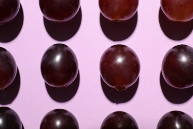 Photo of Fresh ripe juicy grapes on pink background, flat lay