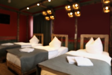Blurred view of stylish hotel room interior with comfortable beds