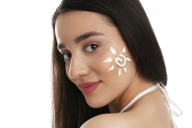 Young woman with sun protection cream on her face against white background