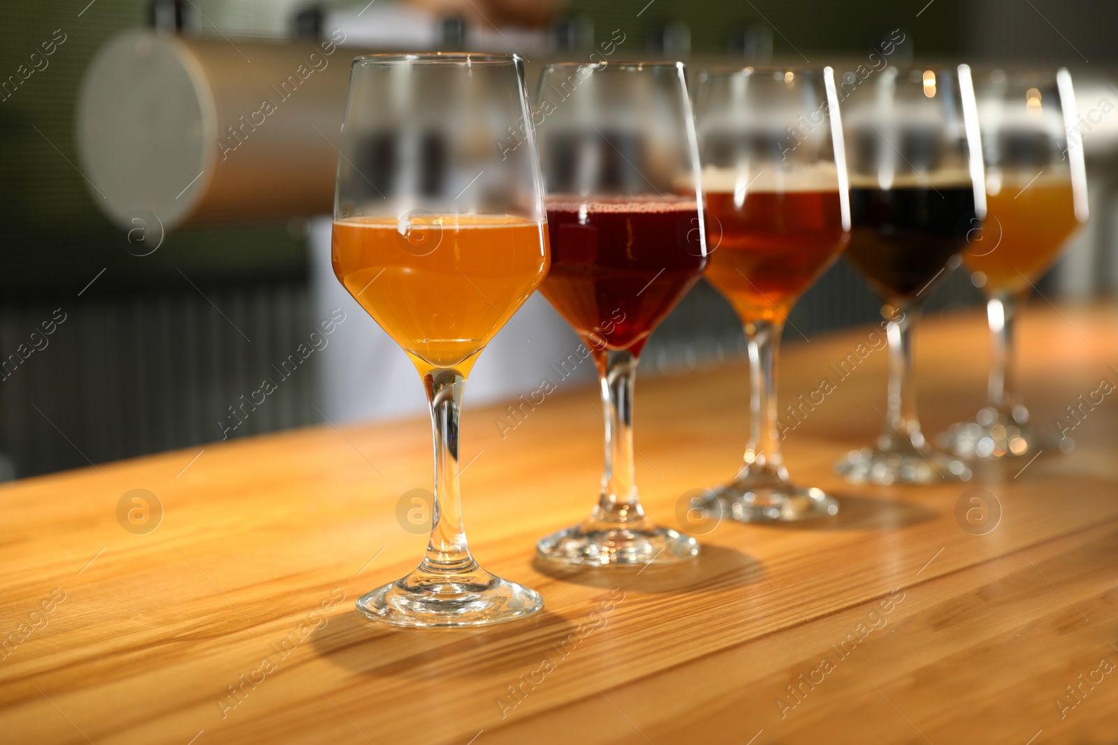 Photo of Different sorts of beer on wooden bar counter