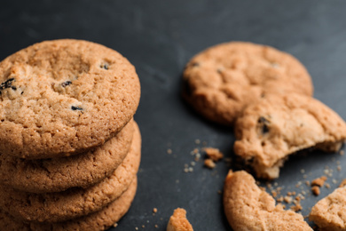 Delicious cookies with raisins on black table, closeup