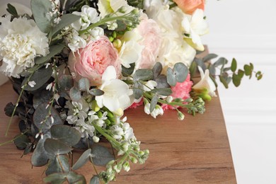 Bouquet of beautiful flowers on wooden table, closeup