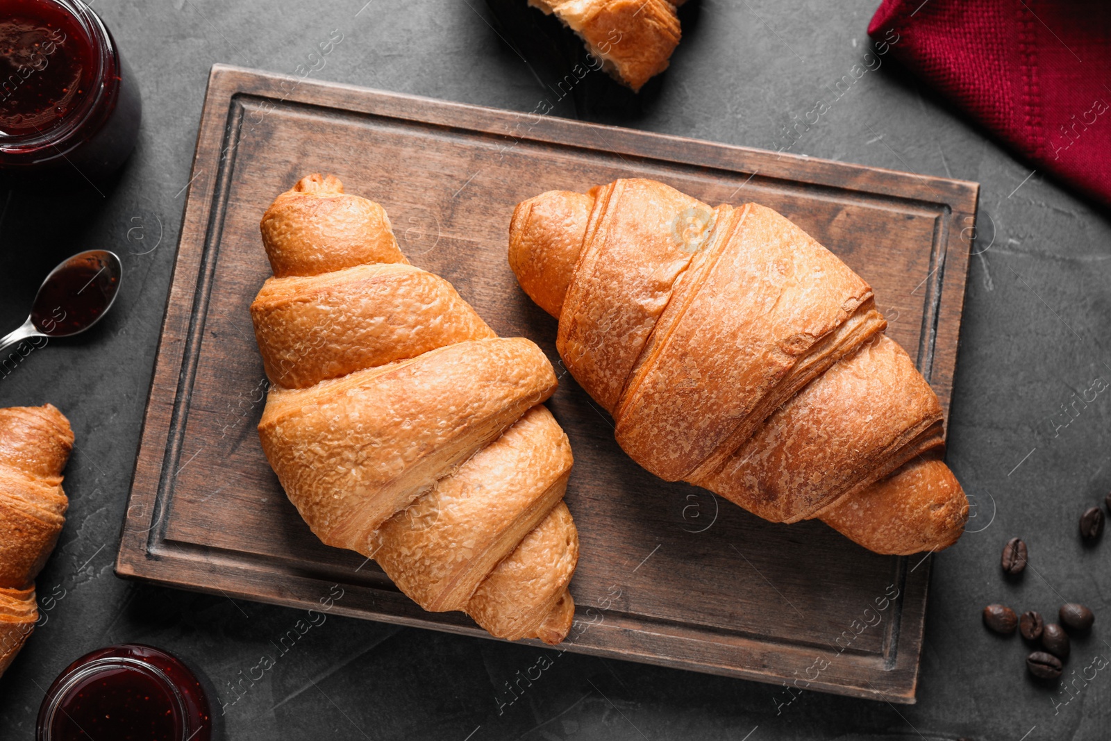 Photo of Flat lay composition with tasty croissants on grey table