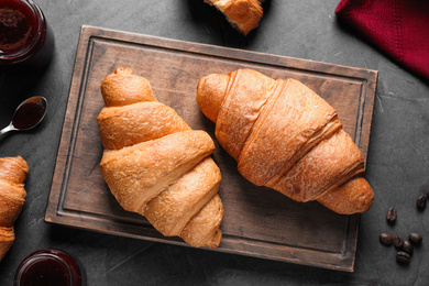 Photo of Flat lay composition with tasty croissants on grey table