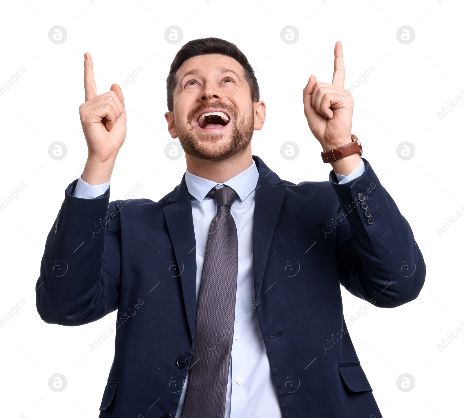 Photo of Handsome bearded businessman in suit pointing at something on white background