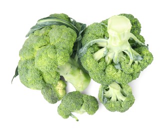 Photo of Pile of fresh raw green broccoli isolated on white, top view